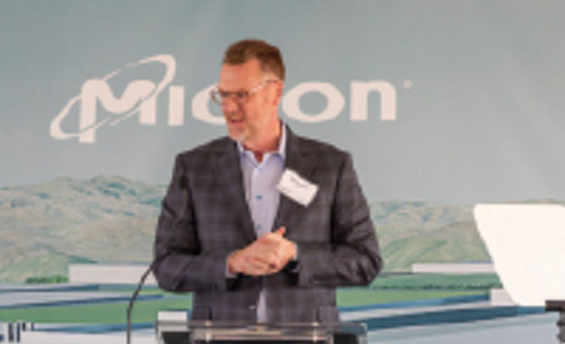 a micron executive speaking at a podium