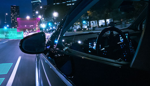 A car driving through a city at night