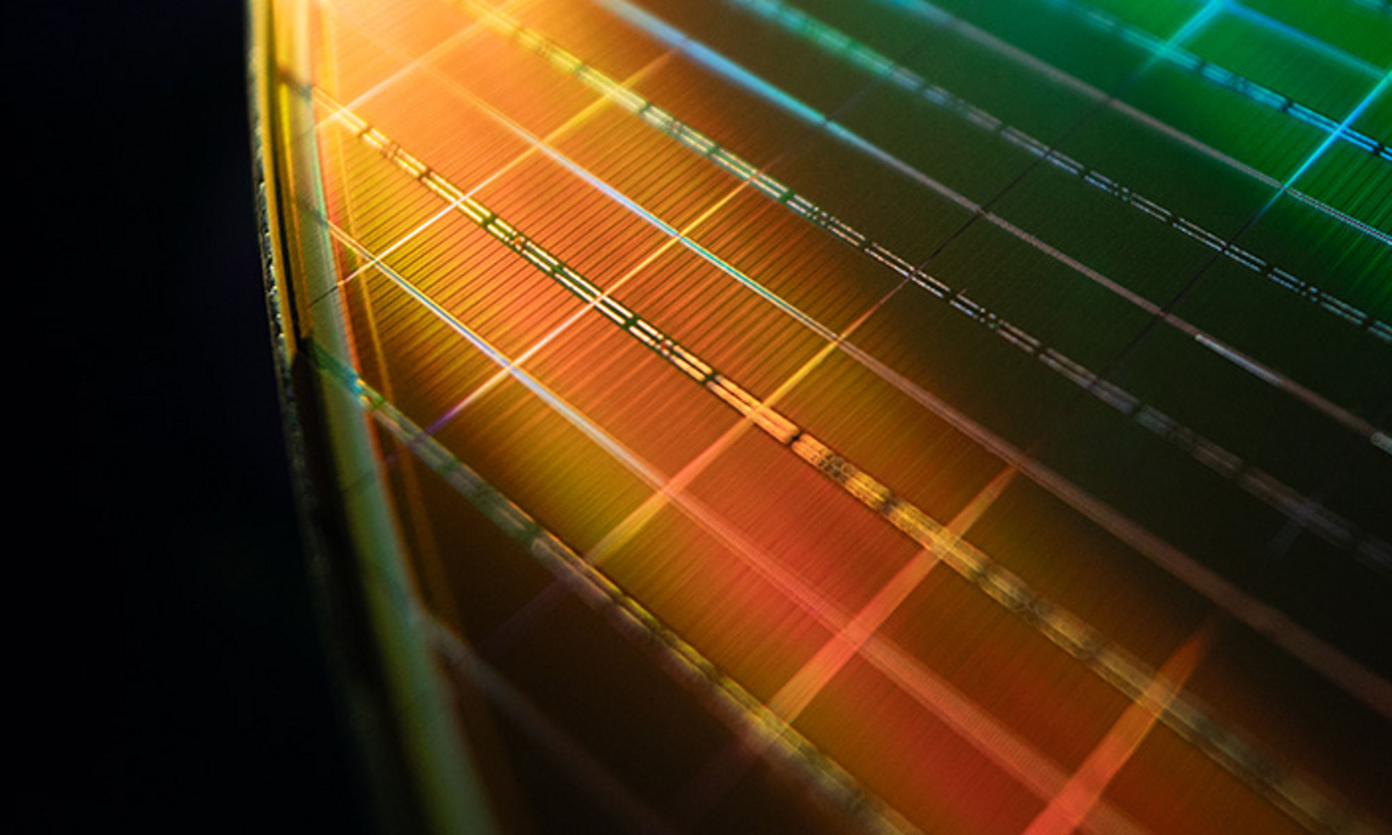 Green and gold lights reflecting off of a wafer