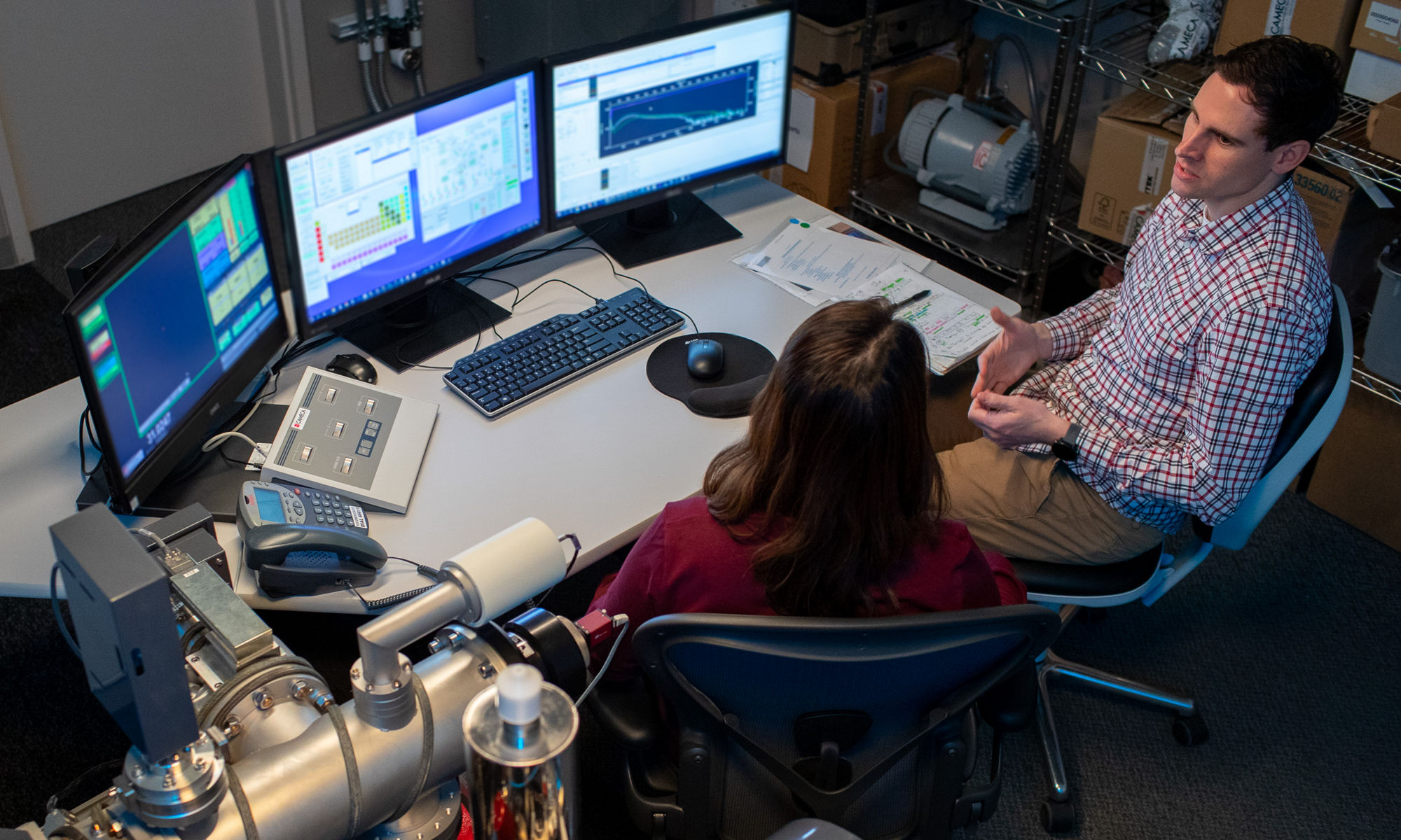 Co-workers collaborating at a computer console in a lab