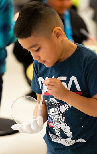 Boy working with bubble and pipette