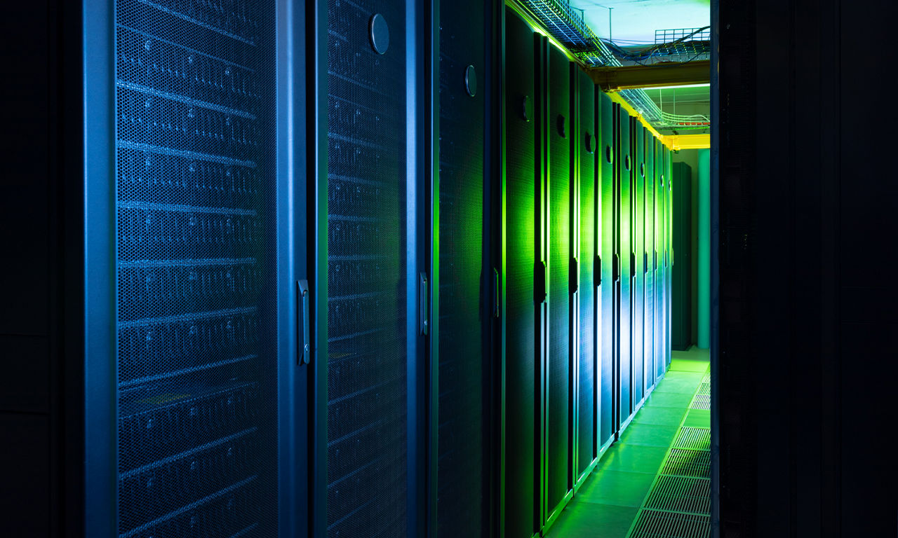 Data center hallway, in blue and green light