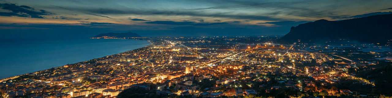    areal view of city at night near beach