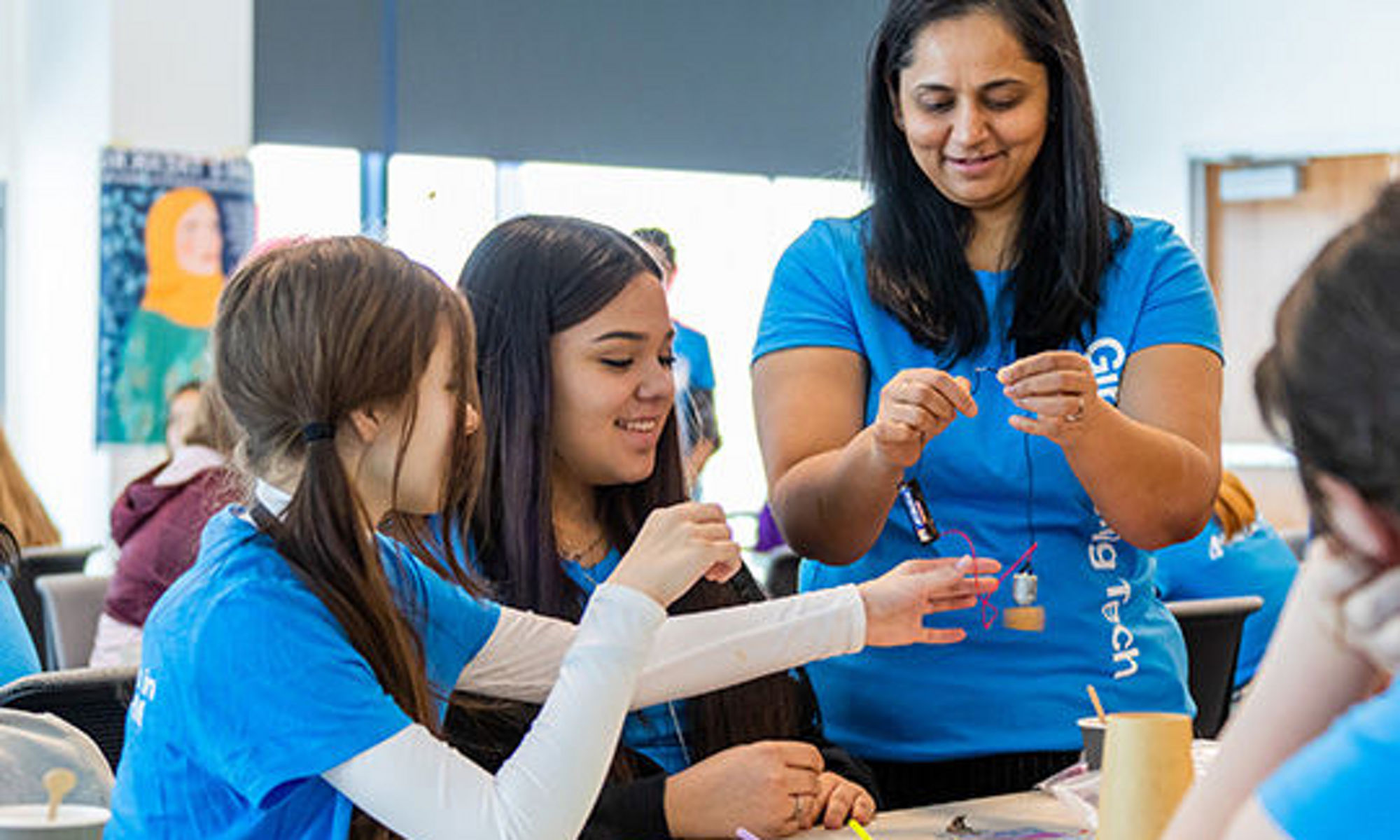 Teacher working with young girls at a Micron STEM event