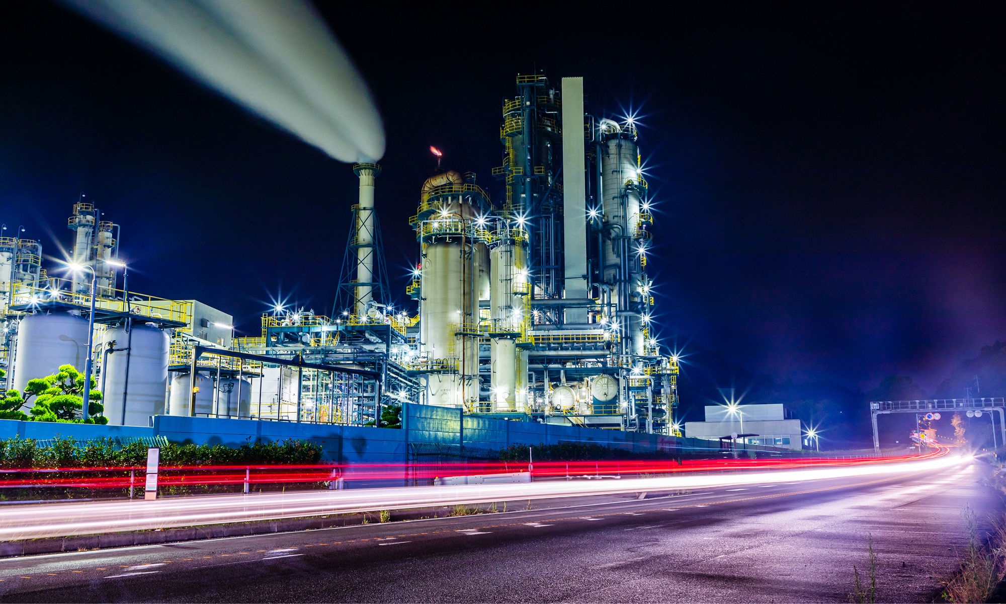 a large fabrication facility glowing with light at night