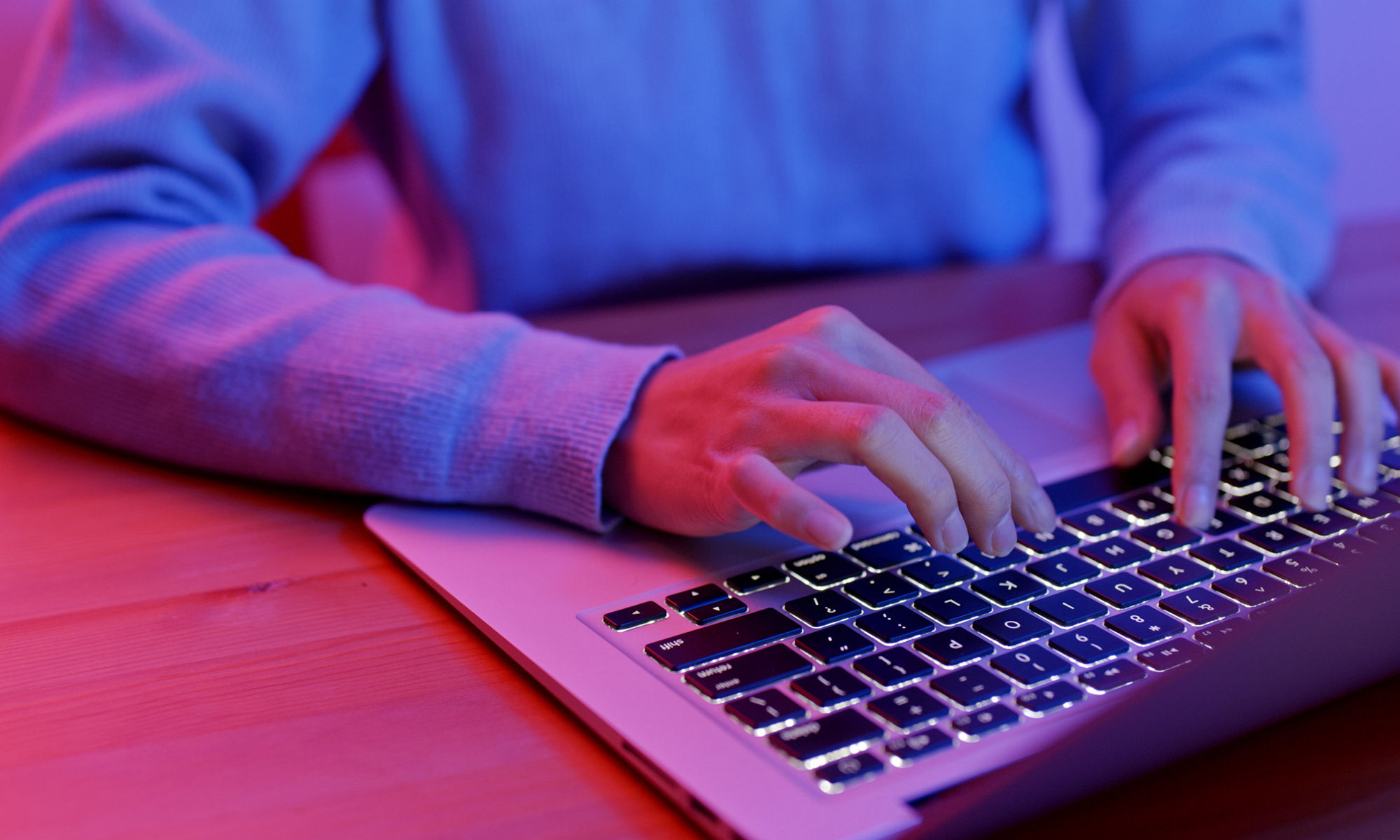 Finger type on keyboard at night