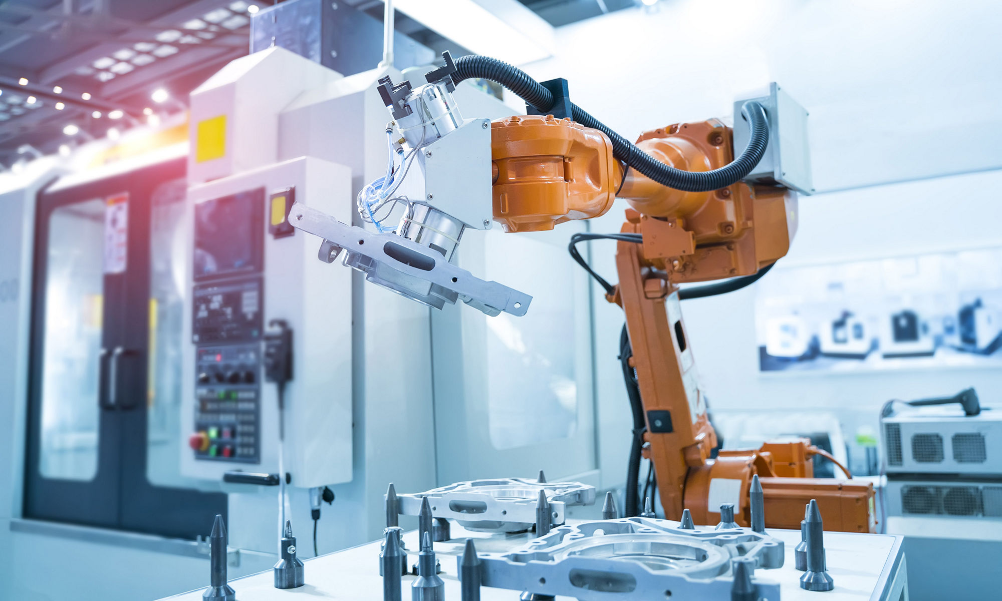 a manufacturing robot arm inside of a fabrication facility