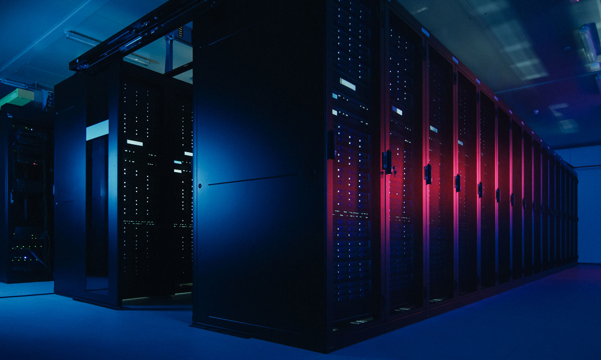 Shot of Data Center With Multiple Rows of Fully Operational Server Racks. Modern Telecommunications, Cloud Computing, Artificial Intelligence, Database, Supercomputer Technology Concept. Shot in Dark with Neon Blue, Pink Lights.