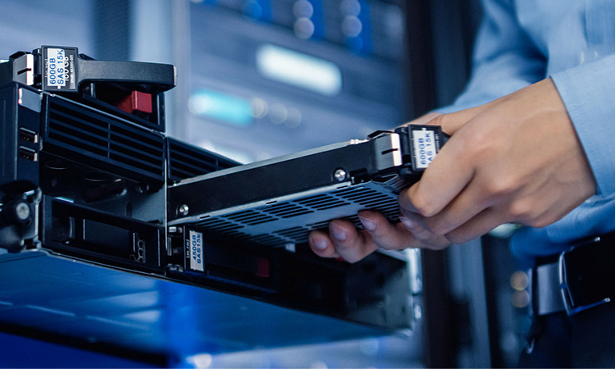 Worker inserting a rack into a server in a data center