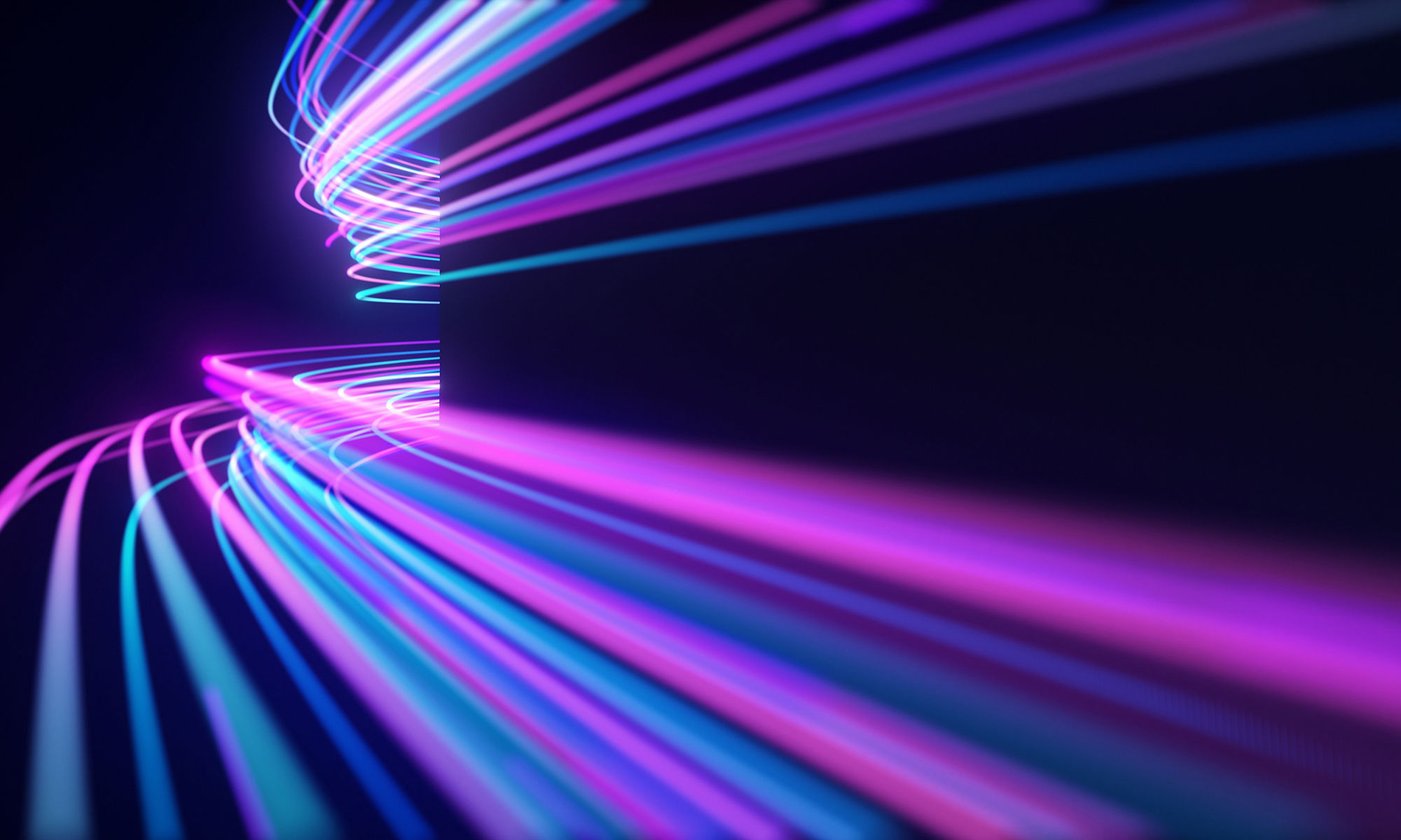 Abstract neon light streaks in pink and blue moving around a corner with black walls