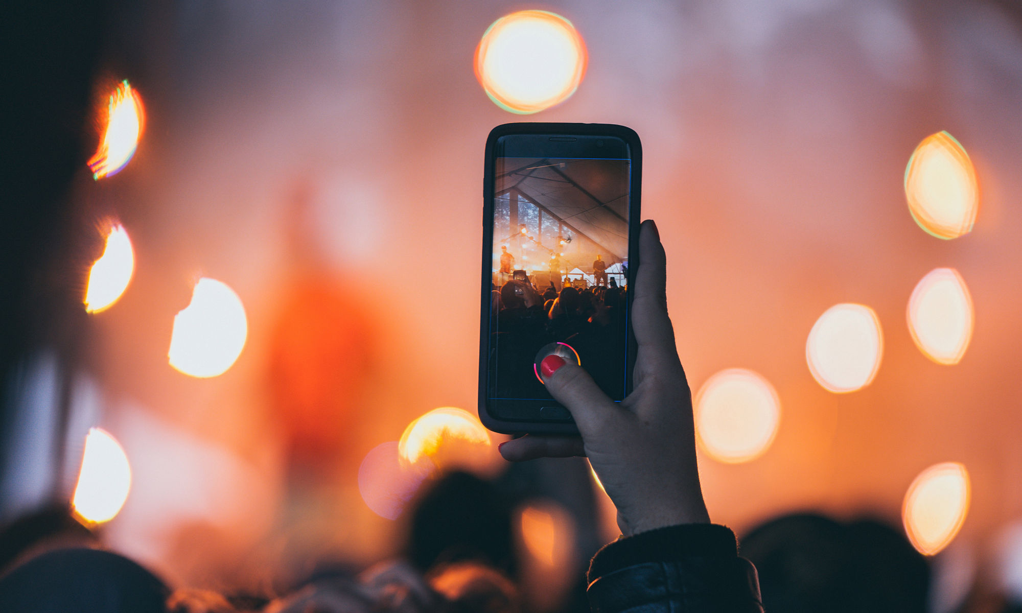 hand holding mobile phone at night