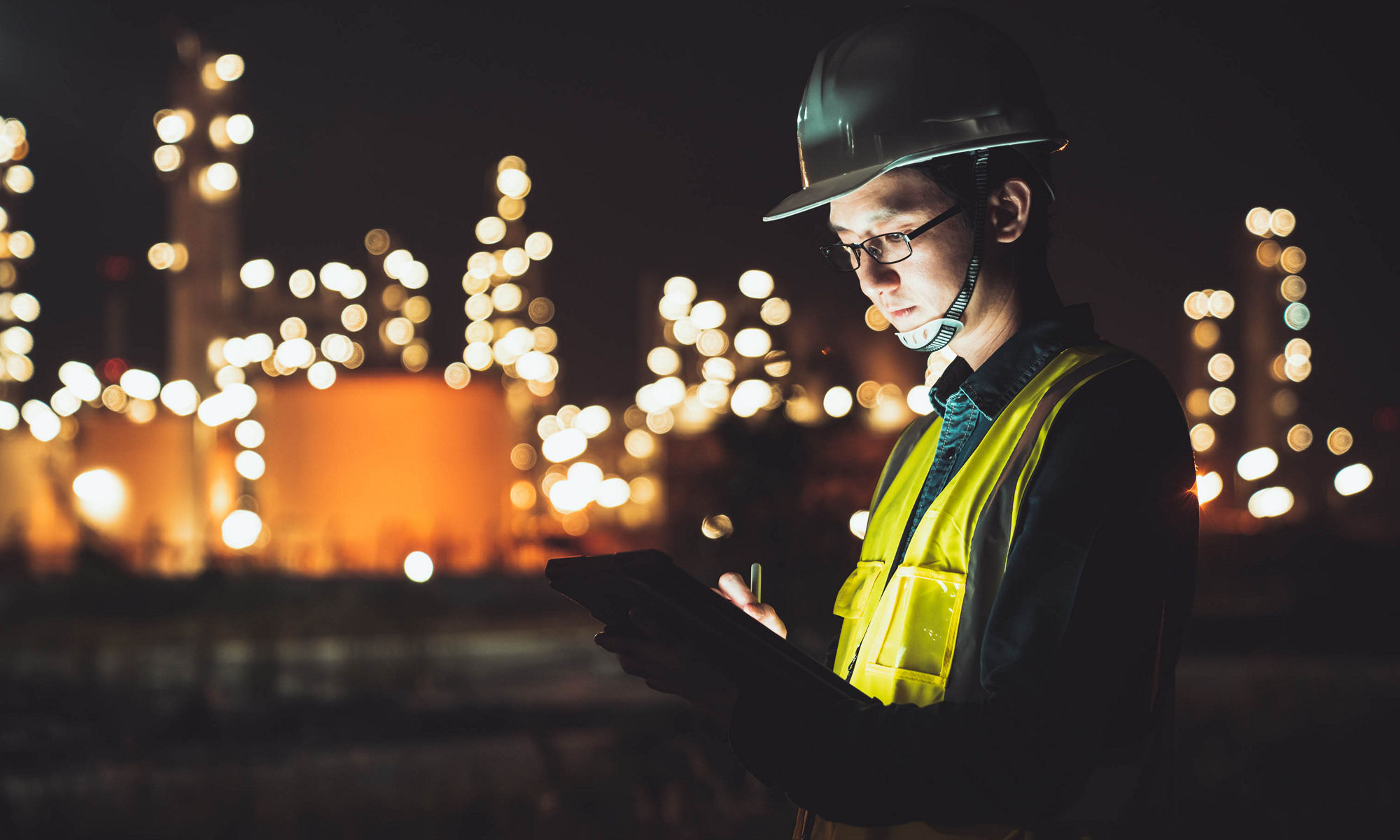 Engineer at night reading a tablet