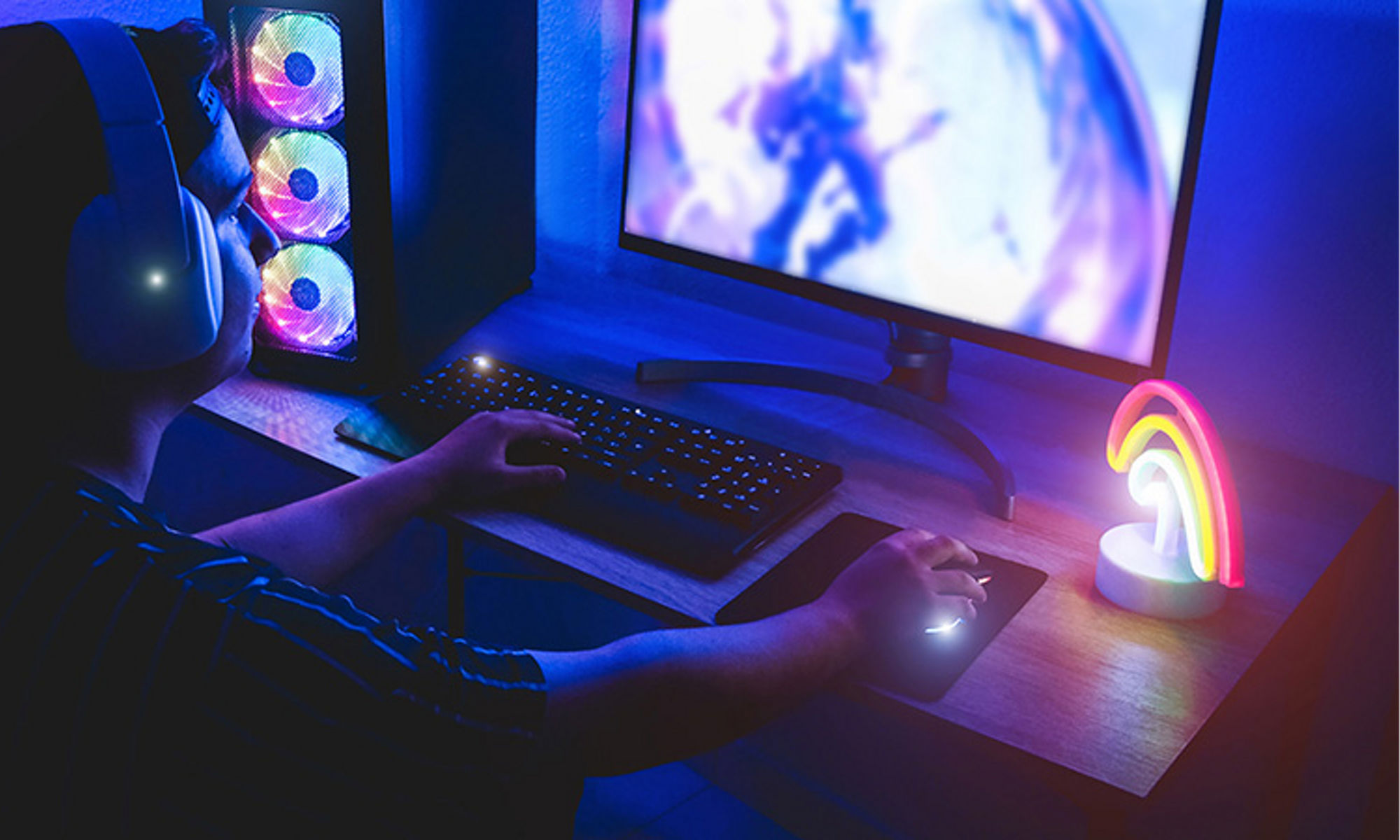 person wearing headset and using the computer infront of him