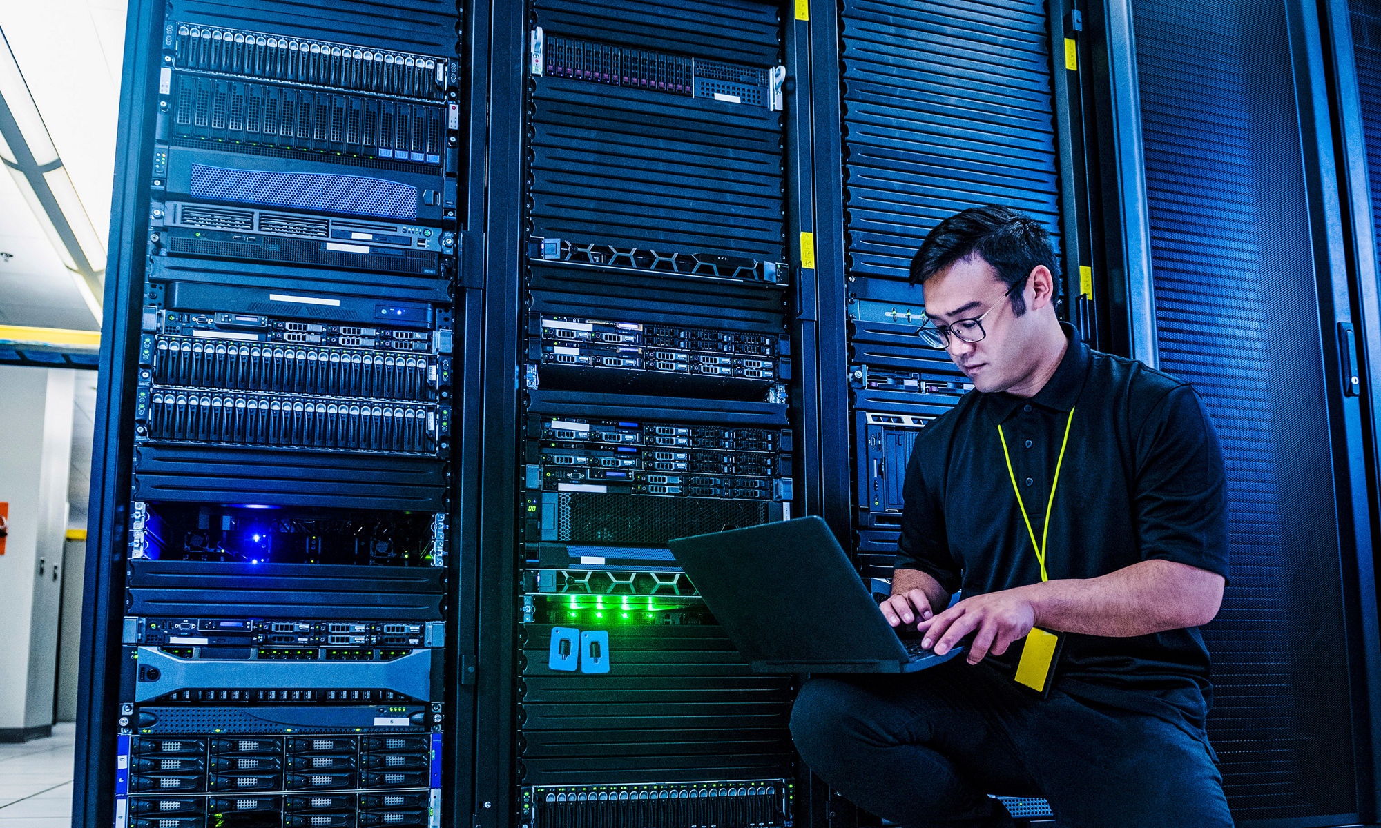 Employee working on server rack in data center