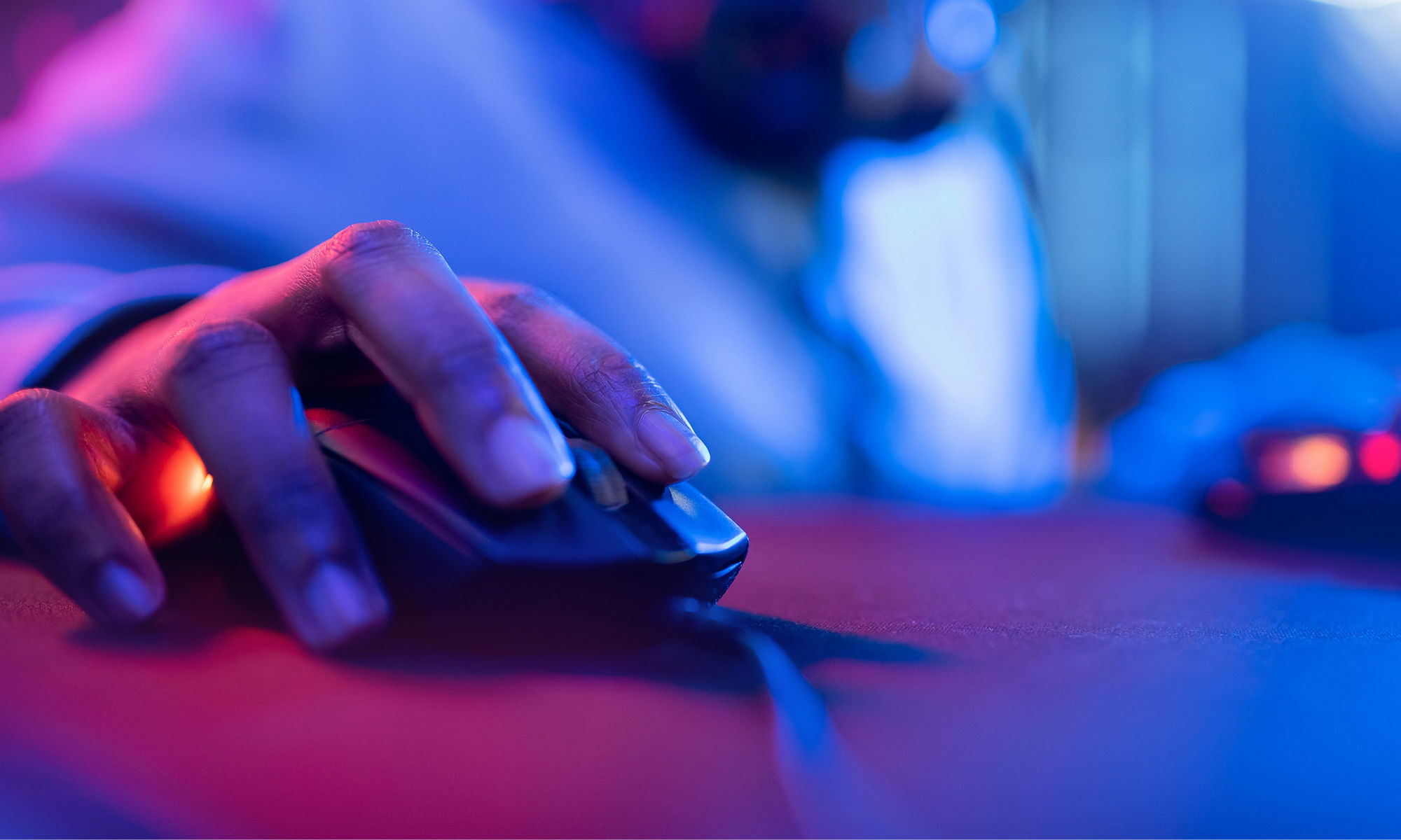 Hand on mouse clicking in pink and blue hues