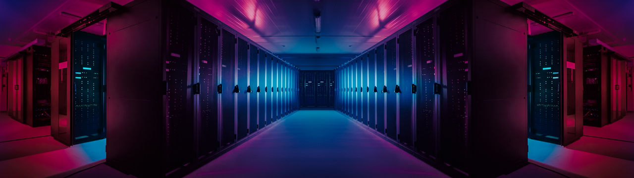 Wide-Angle Panorama Shot of a Working Data Center With Rows of Rack Servers. Red Emergency Led Lights Blinking and Computers are Working. Dark Ambient Light.