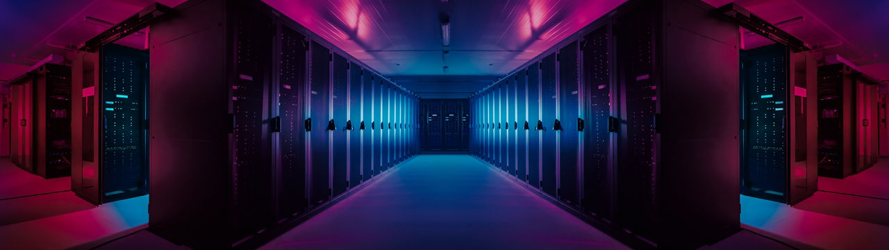 Wide-Angle Panorama Shot of a Working Data Center With Rows of Rack Servers. Red Emergency Led Lights Blinking and Computers are Working. Dark Ambient Light.