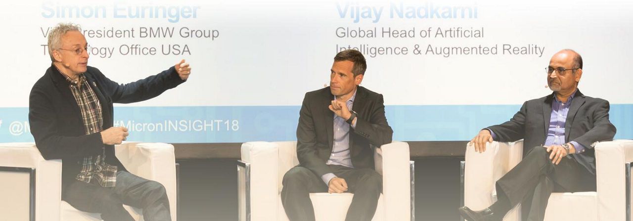 3 men on stage having a conversation