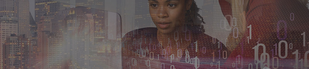    two female workers staring at computer screen