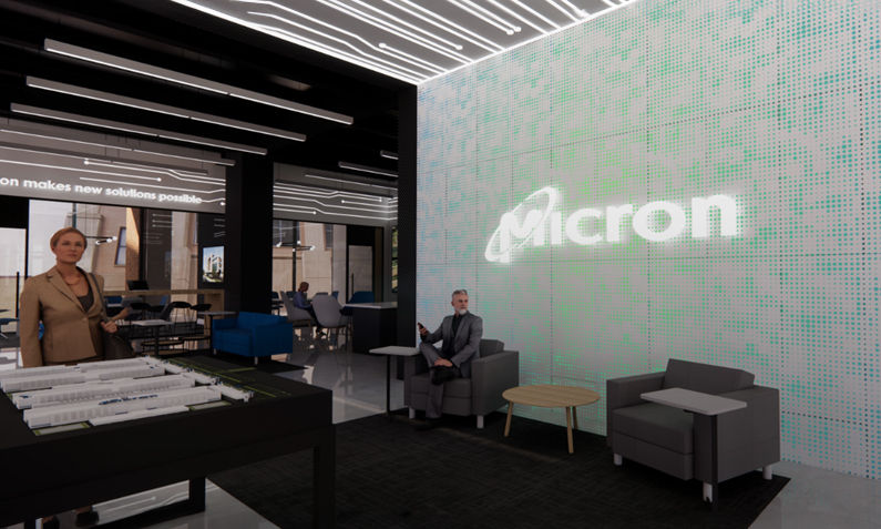 Man sitting in front of Micron LED logo board