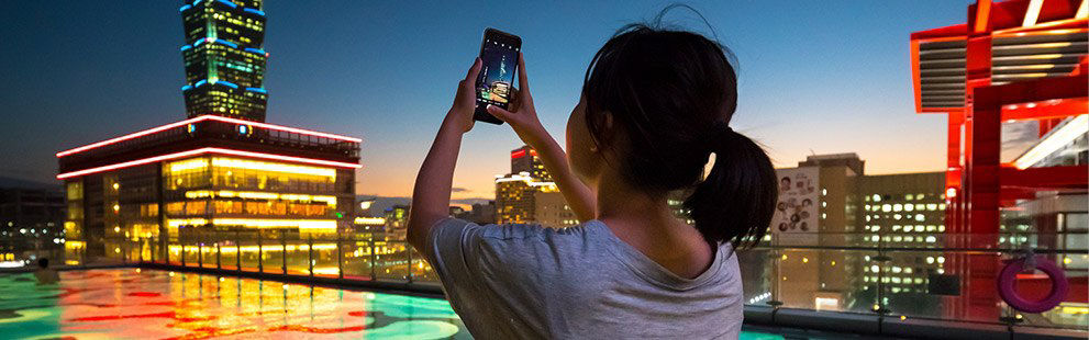 woman taking a photo on smartphone