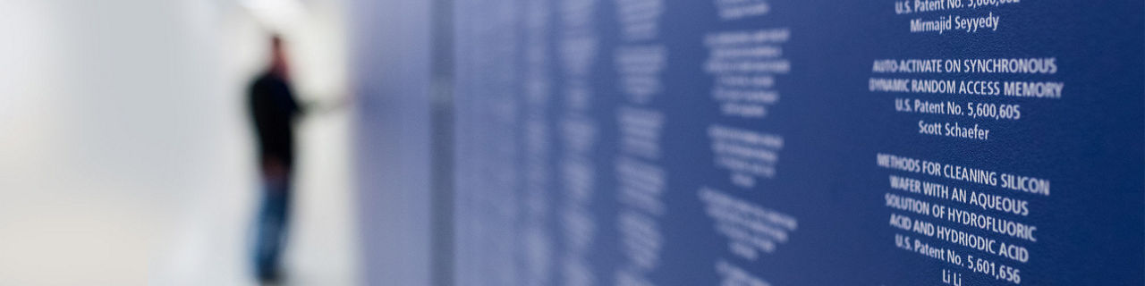 blurred picture of a person looking at a wall of awards