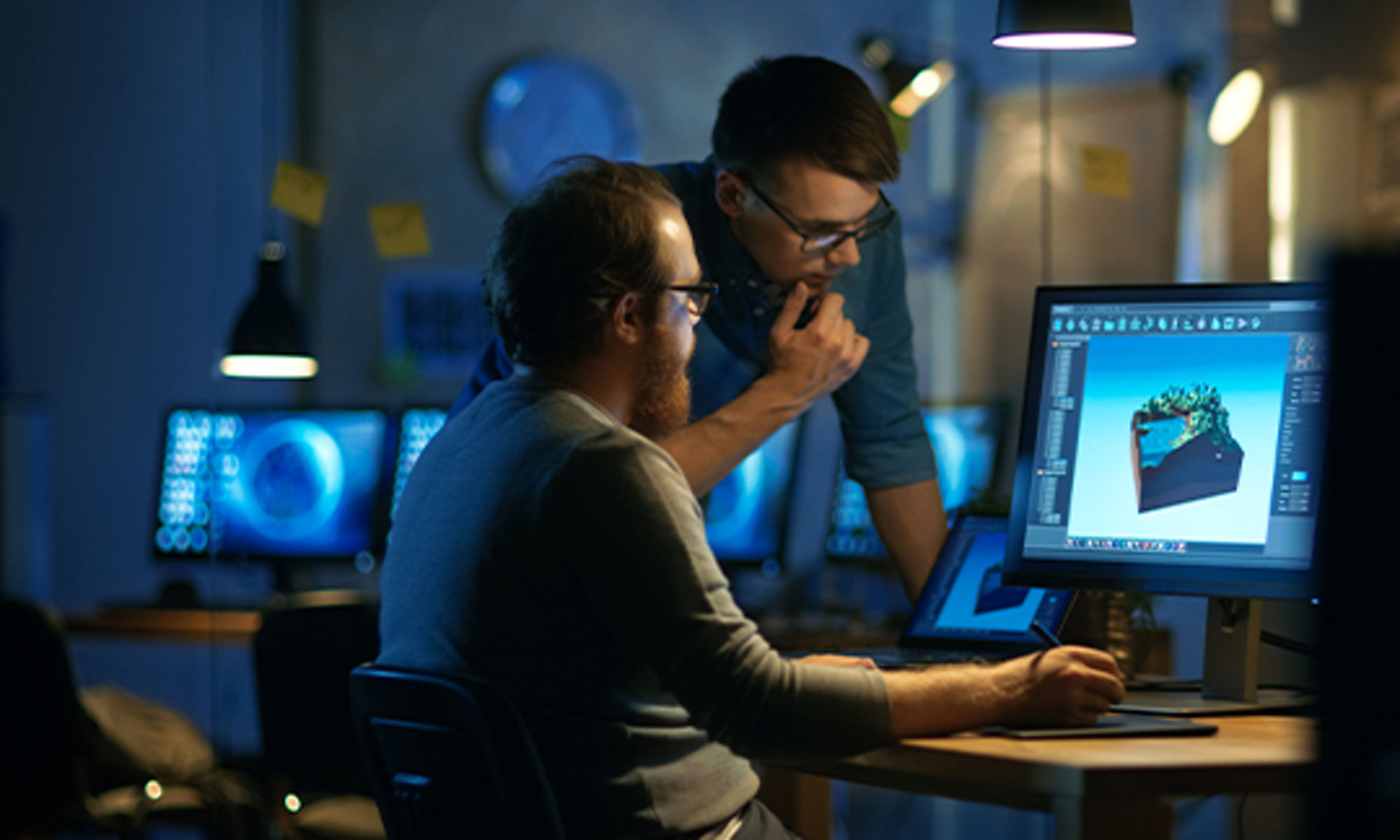 2 men looking at a monitor screen