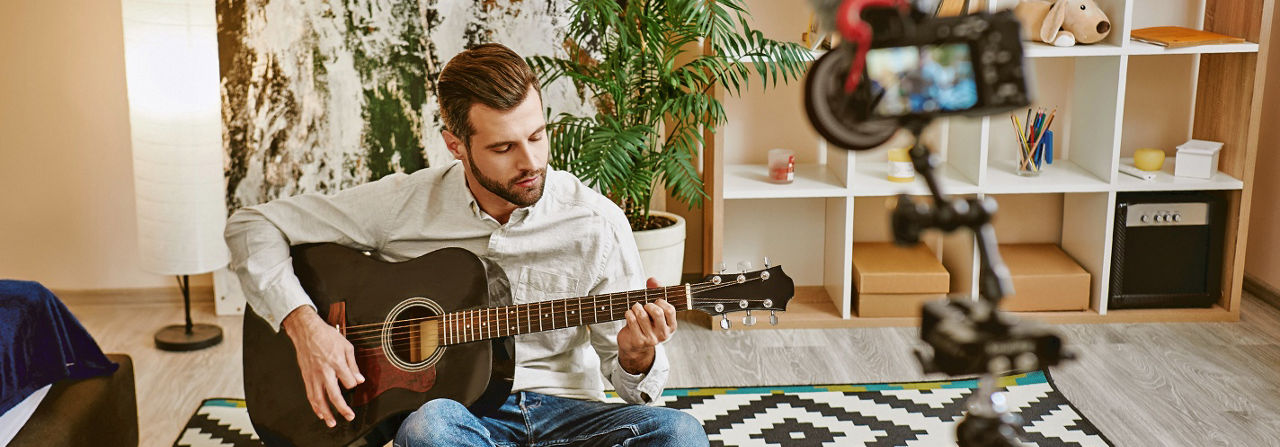 man playing guitar in a studio