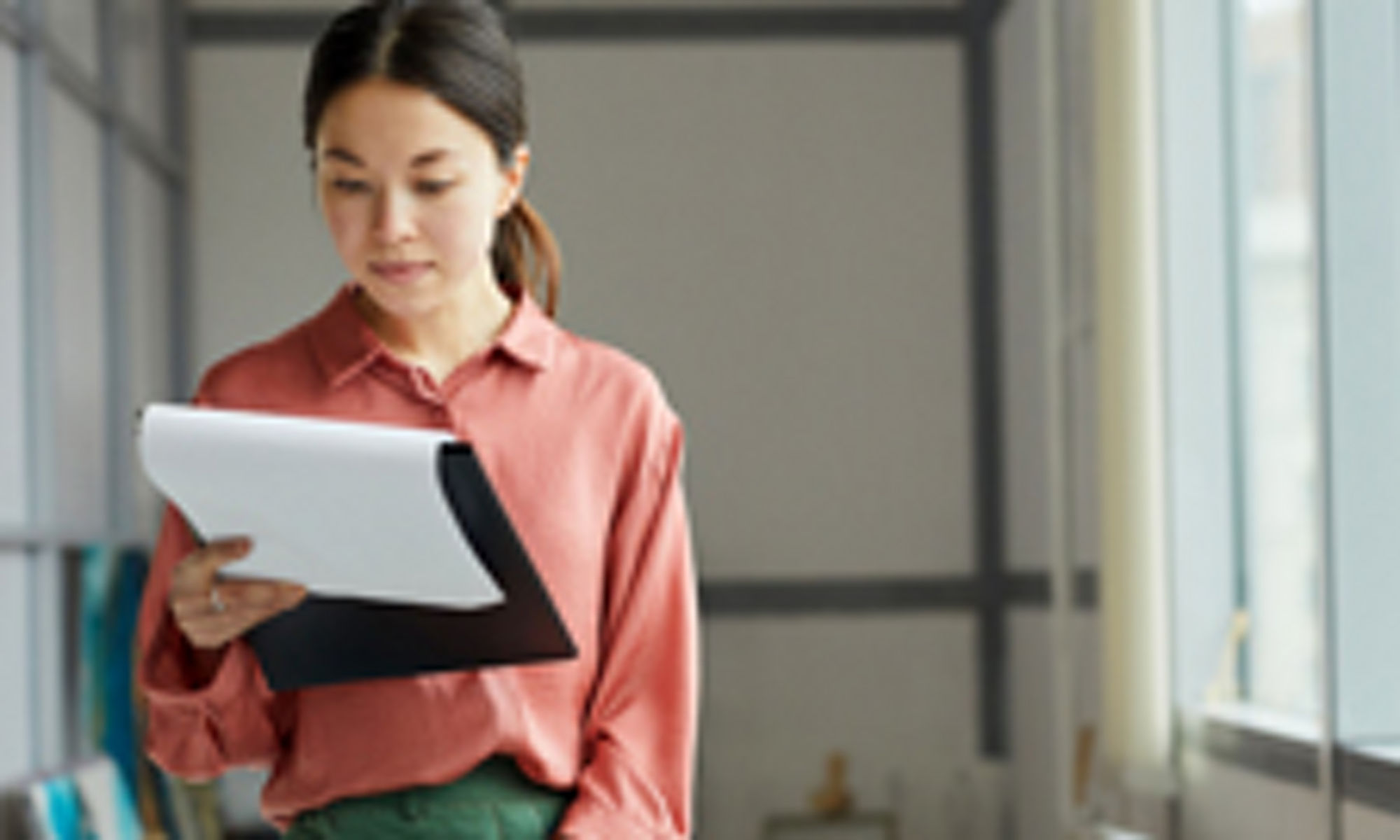 woman reading a memo in an office