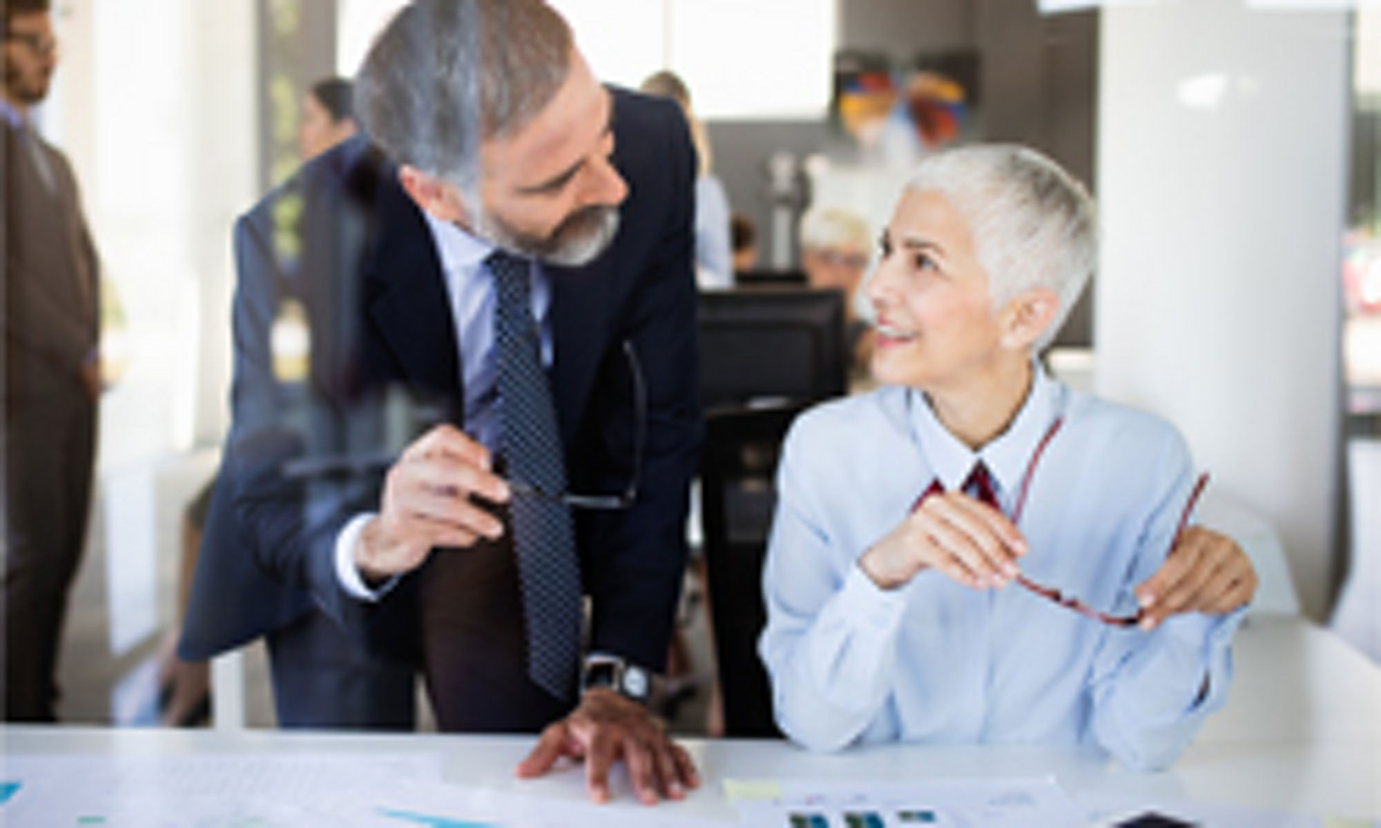 Man and women with gray hair talking to each other