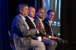 Micron Chairman, President and CEO Sanjay Mehrotra along with other business executives on sitting on stage