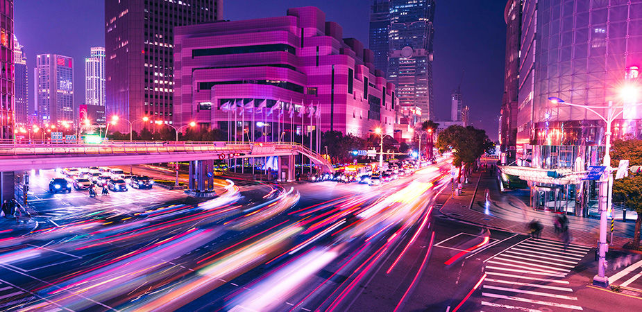 Dynamic city traffic at night symbolizing the fast data transfer enabled by Micron software and drivers