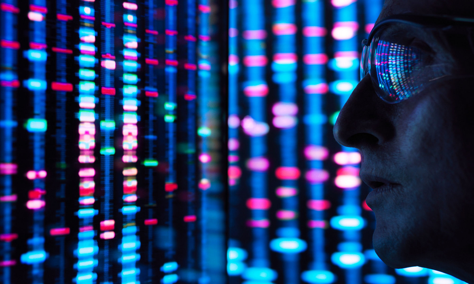 close up of man standing in front of illuminated server