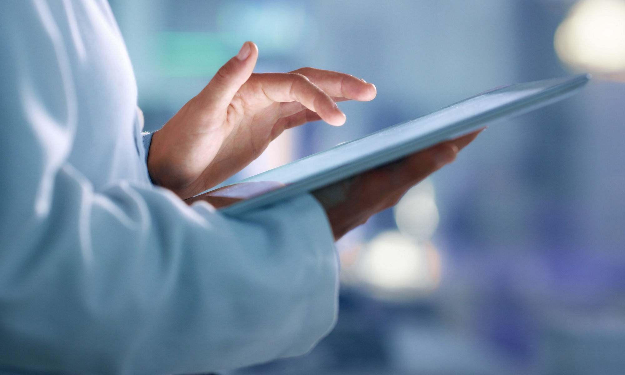 Doctor, researcher or scientist browsing the internet on a tablet for information while working at a lab, science facility or hospital. Expert, medical professional or surgeon searching the internet