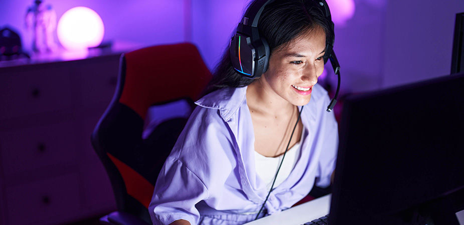 tech support woman in purple shirt wearing headphones and looking at computer 
