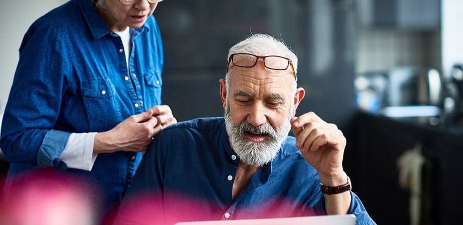 Male doctor of color reviewing a document with two doctors in the background