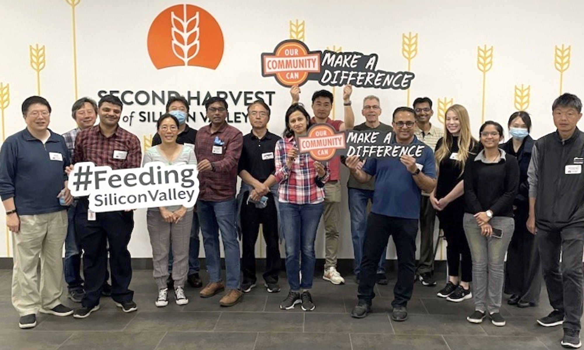 group of people and some holding a banner named feeding silicon valley and make a difference