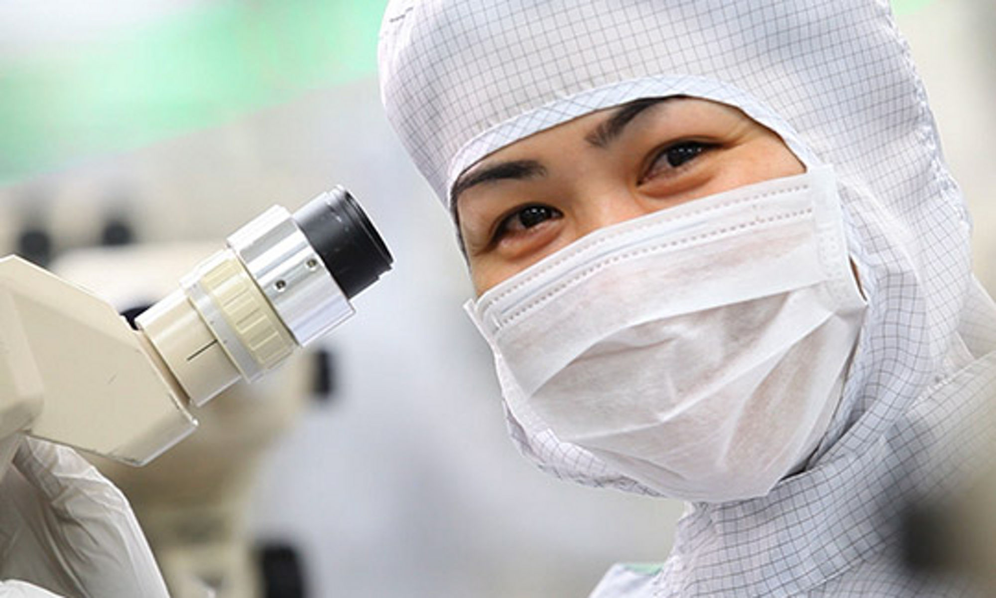 Woman working with microscope in a lab