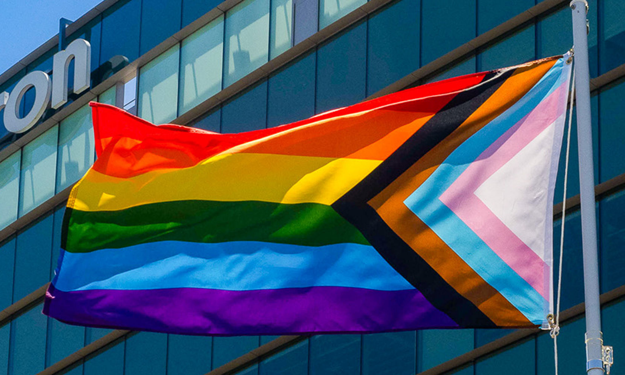 Micron logo on building with pride flag in the front