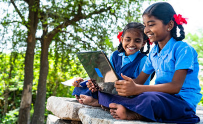 handheld shot of Village school girl kids seriously busy working on laptop - concept of education, technology and knowledge.