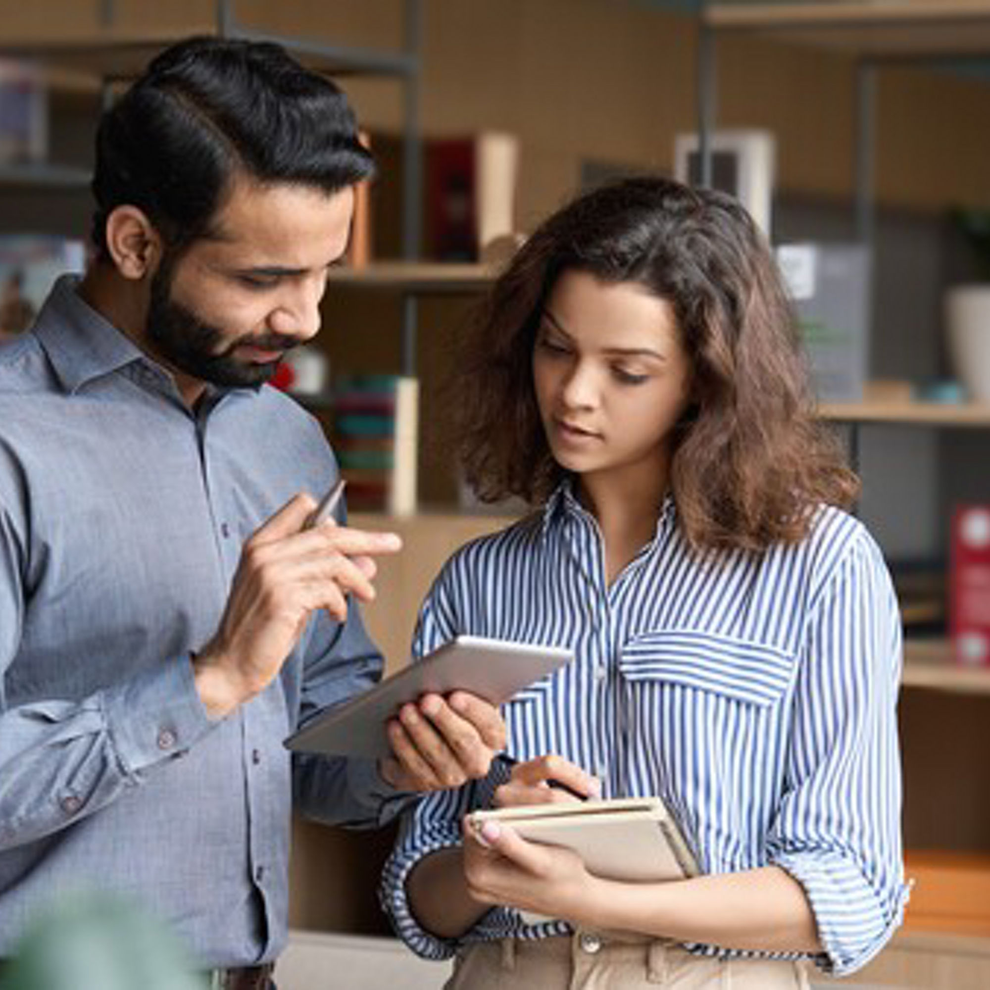 Co-workers looking at a mobile device