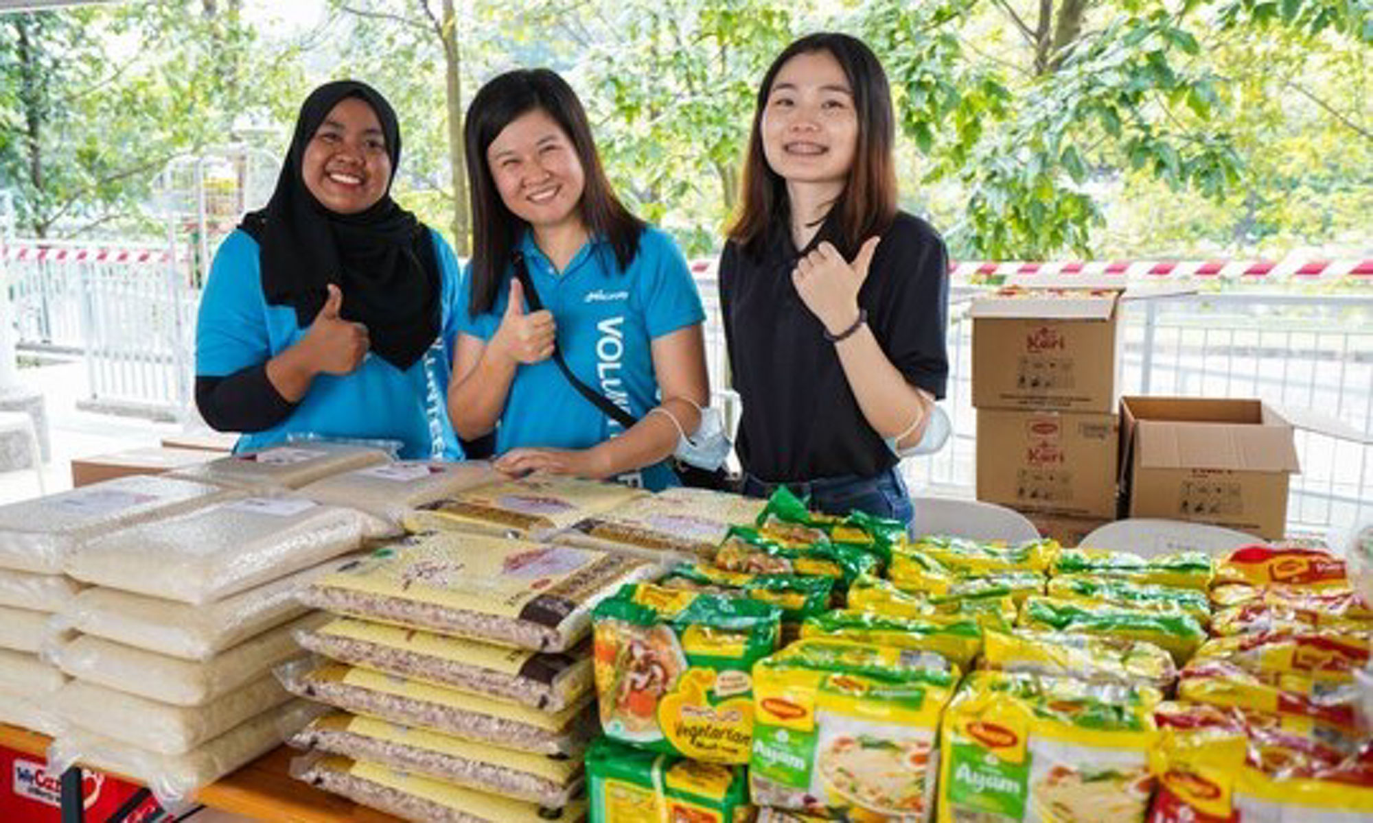 image of girls standing next to a table with food supplies