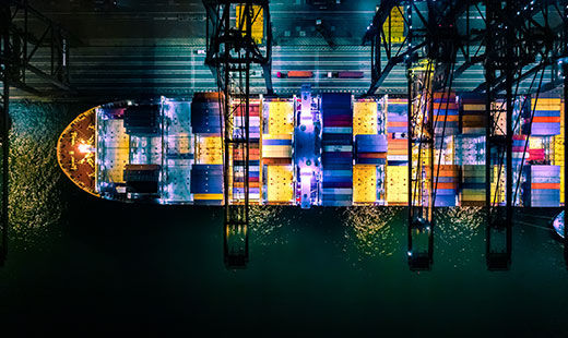 Shot from above: Cargo ship in the water with containers. 