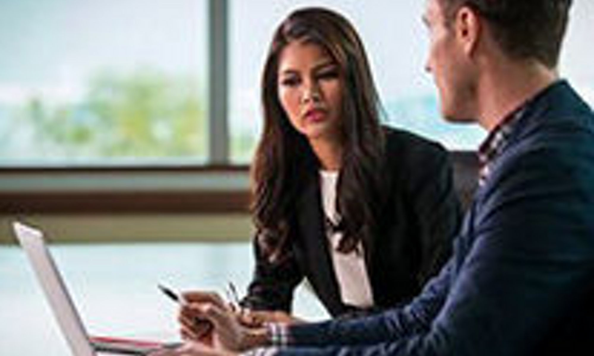 A team of women and men collaborate at work