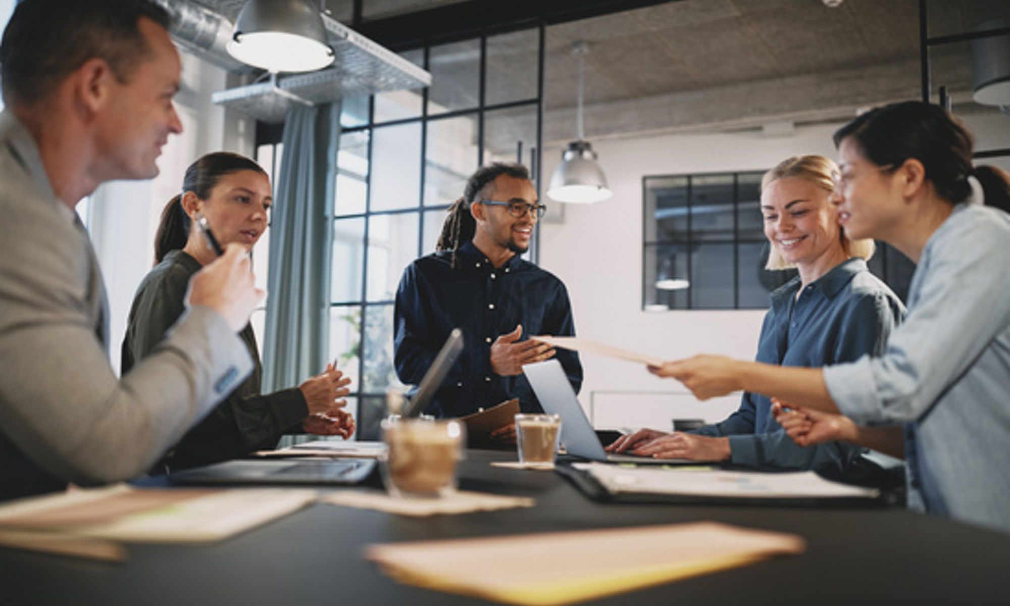 A team of women and men collaborate at work