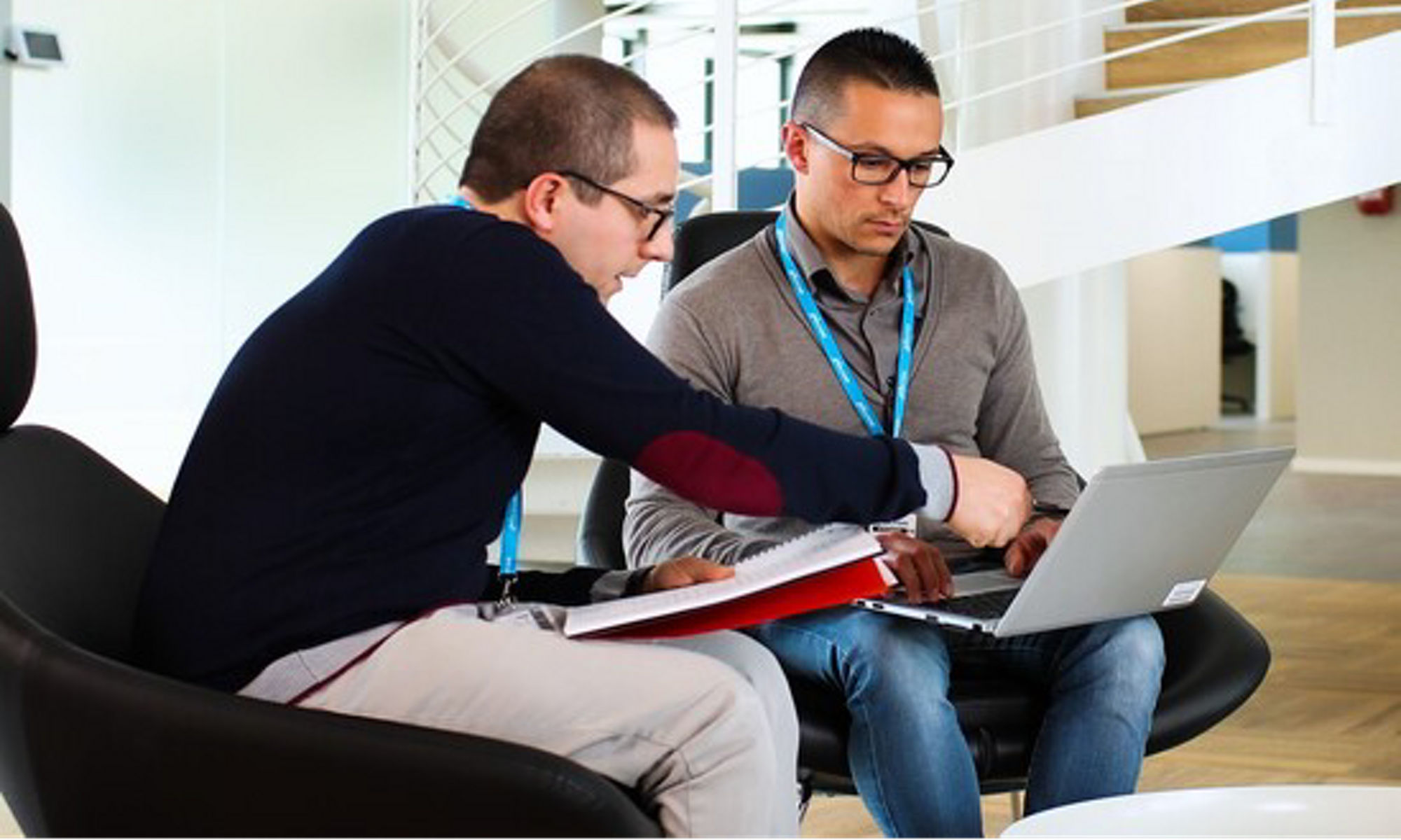 Two co-workers working at a laptop