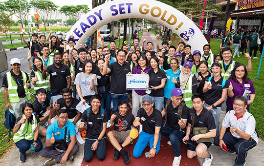 A large group of Micron team members posing at a volunteer event