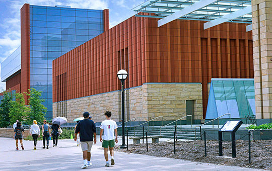 Students strolling across a university campus