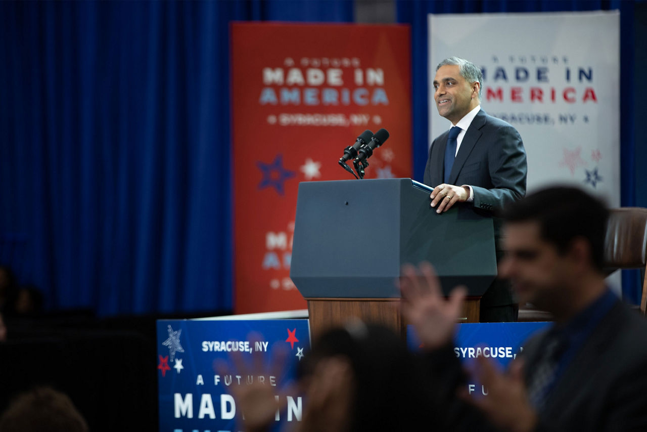 A person on stage addressing the audience