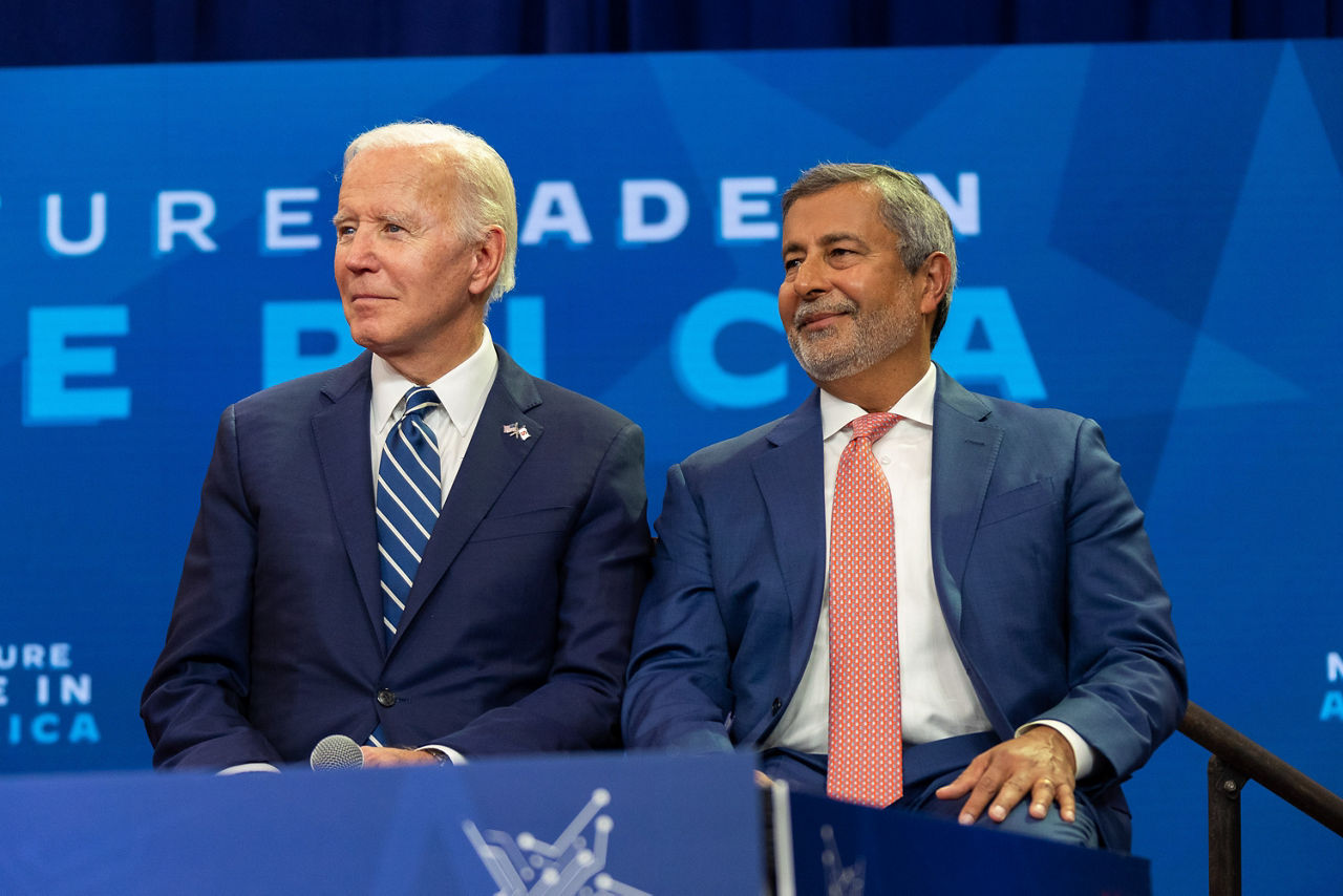 President Joe Biden  and Micron Chairman, President and CEO Sanjay Mehrotra sitting on the stage